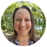 Circle shaped headshot of mindfulness coach and meditation teacher, Robyn Gold, with trees in the background.